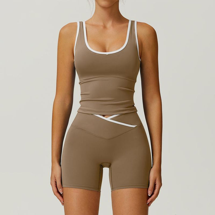 Stylish women's yoga outfit with sculpting high-waist shorts & matching sports bra for gym & fitness.