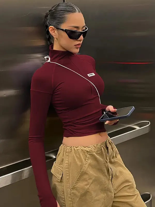 Women's Sculpting Zip Crop Top with long sleeves, offering modern style and a flattering fit.