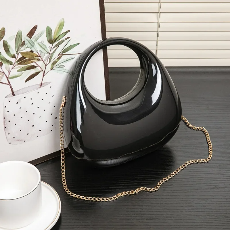 Glossy black sculptural acrylic clutch, stylish women's evening party bag.