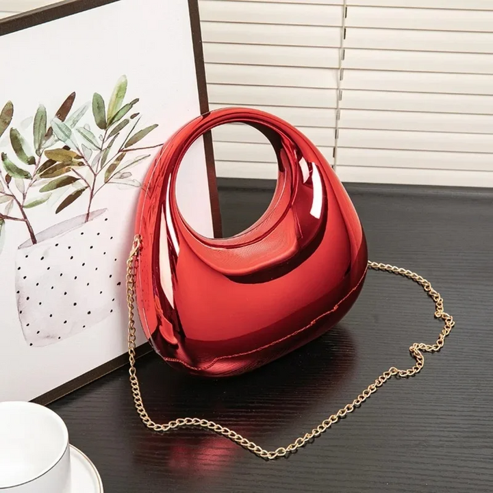 Sleek sculptural acrylic shoulder bag for women, evening fashion accessory.