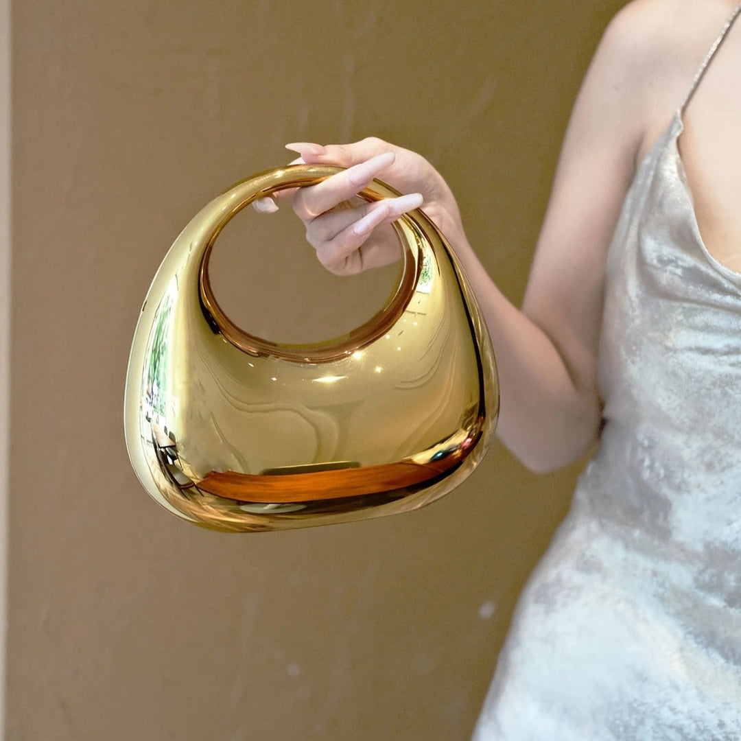 Glossy acrylic sculptural clutch bag, a chic women's evening accessory.