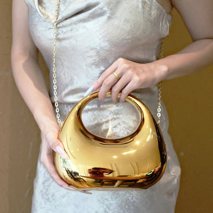 Women's glossy acrylic clutch, sculptural design for special occasions.