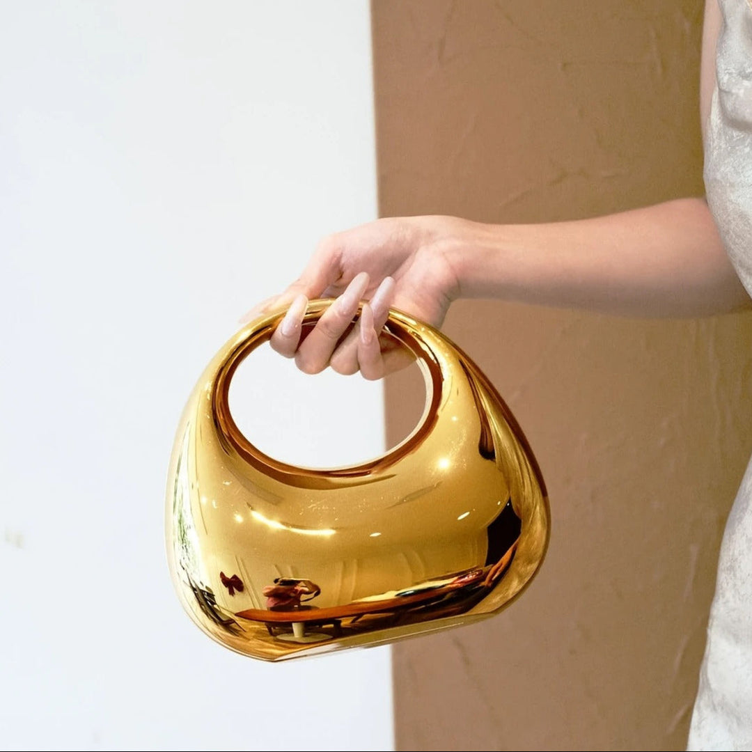 Elegant women's sculptural acrylic party clutch with a sleek finish.