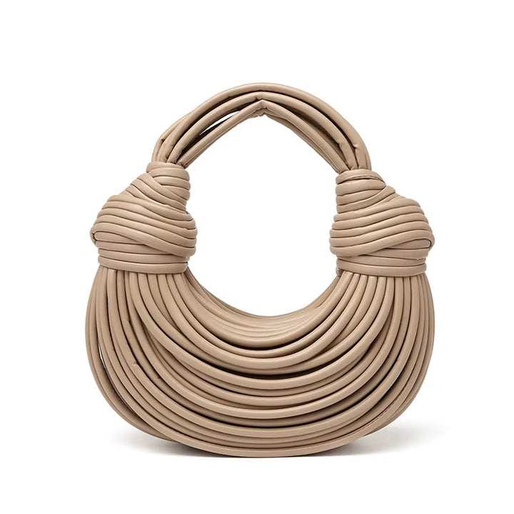 Modern sculptural vegan leather handbag, a sleek women's fashion bag for shoulder or crossbody use.
