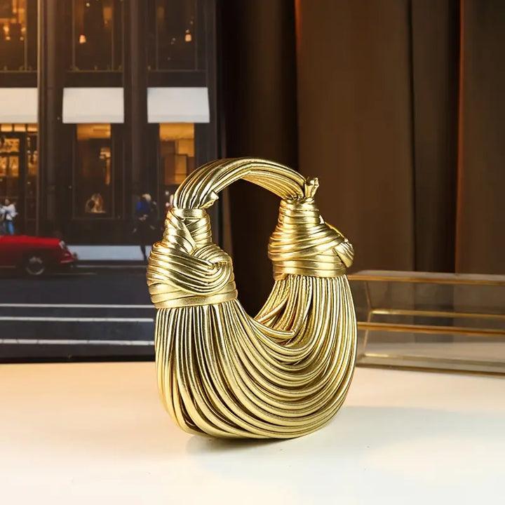 Chic sculptural vegan leather handbag, a luxury vegan accessory with detachable strap for women.