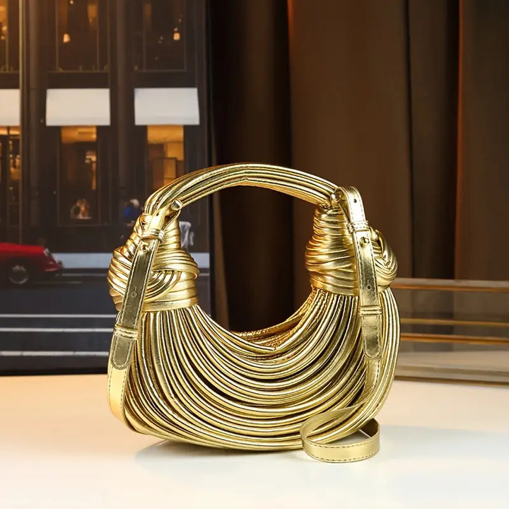 Versatile women's vegan leather handbag; sculptural design, wear as crossbody or shoulder bag.