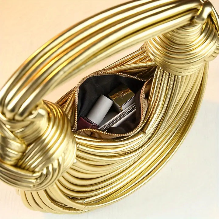 Statement sculptural vegan leather handbag, a fashion-forward women's accessory with detachable strap.