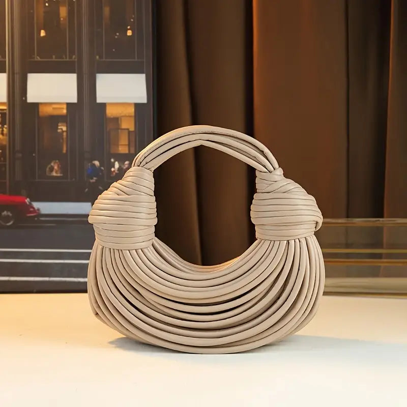 Sculptural vegan leather women's handbag, a stylish crossbody and shoulder bag accessory.