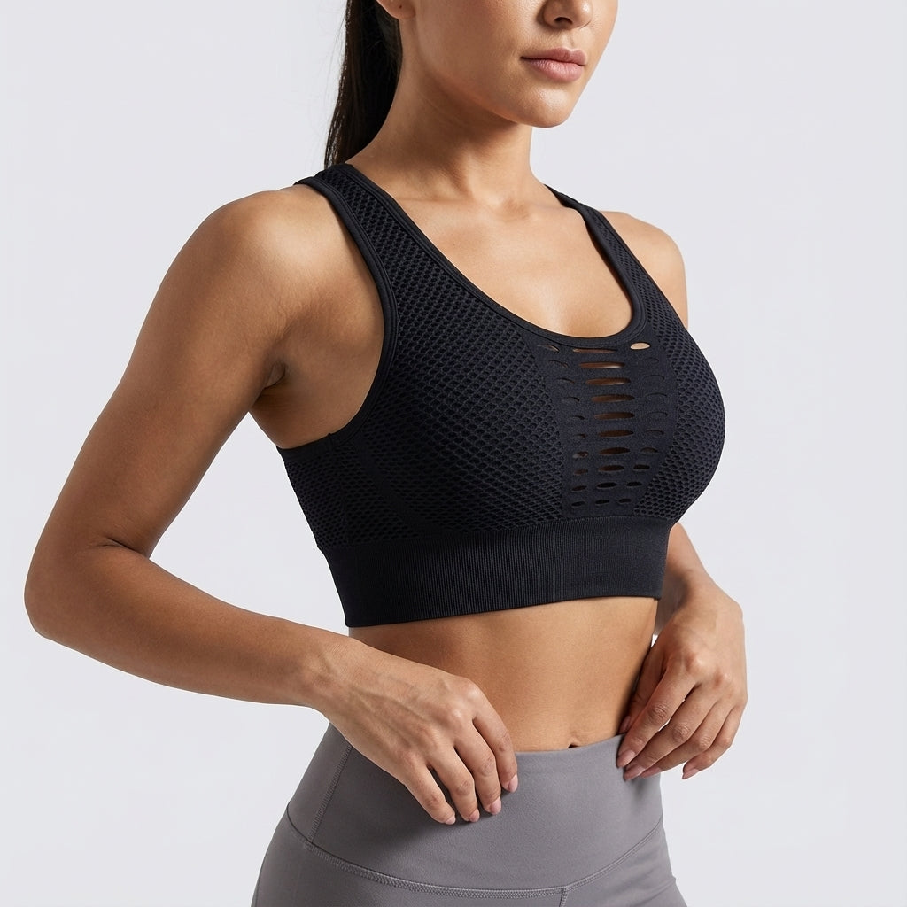 Active woman stretching in a blue seamless breathable sports bra, demonstrating flexibility and support during a workout.