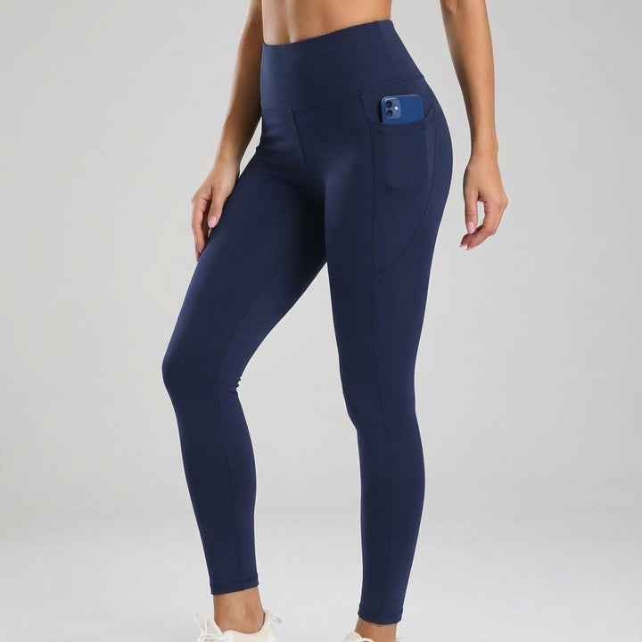 Pair of seamless high-waisted fitness leggings in nude color with convenient thigh pockets