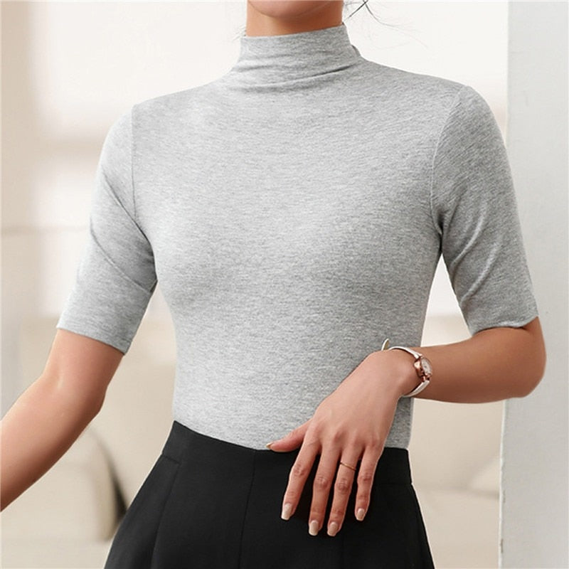 All-season women's seamless roll neck top. Soft, figure-hugging long sleeve, perfect for layering or chic standalone wear.