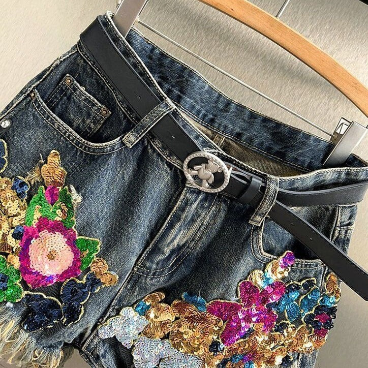 Close-up of women's sparkly floral sequin shorts, intricate embellishments create a glamorous party wear look.
