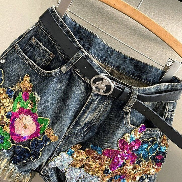 Close-up of women's sparkly floral sequin shorts, intricate embellishments create a glamorous party wear look.