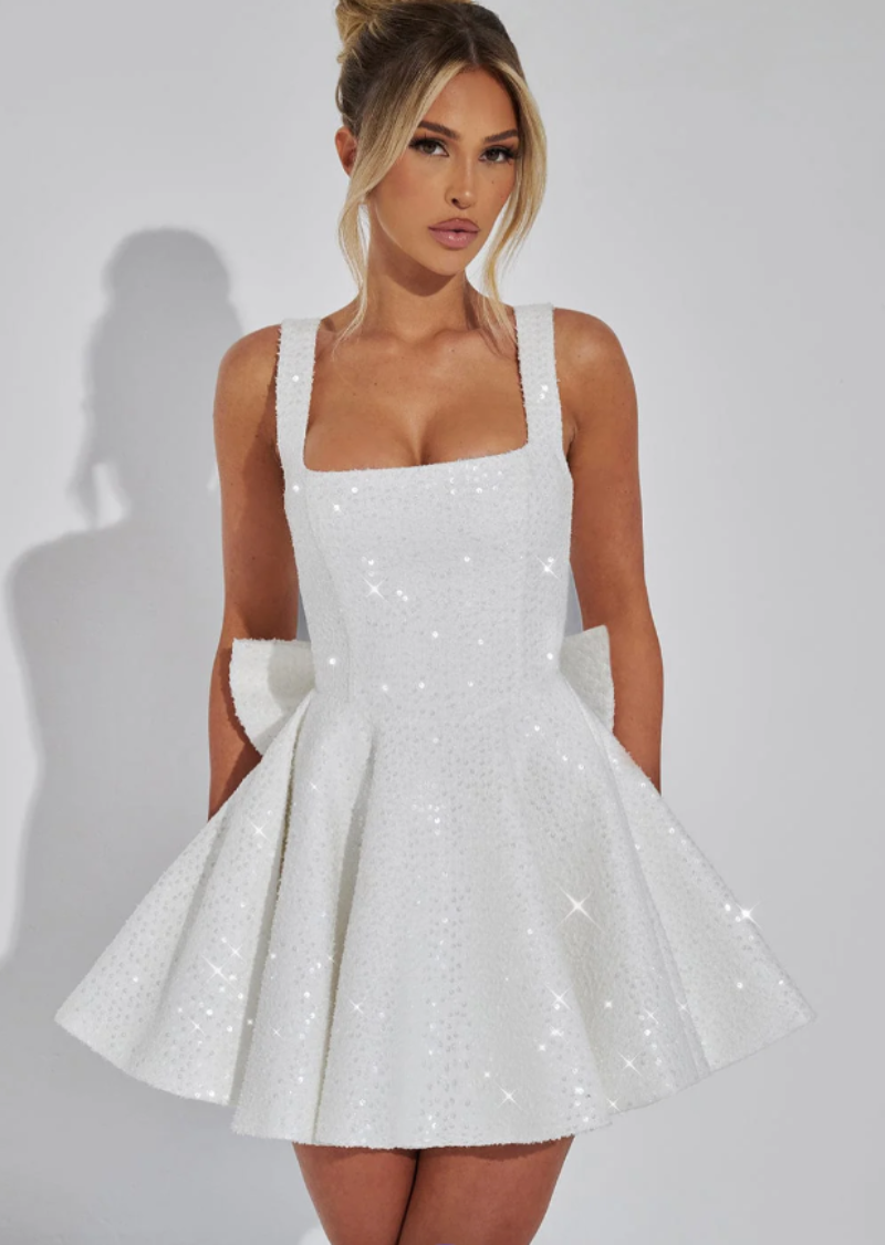 Sparkling sequin skater dress for women, featuring a chic bow and flare skirt, ideal for homecoming.
