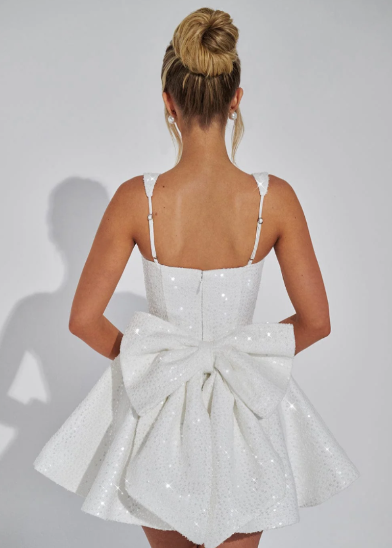 Glamorous sequin skater homecoming dress for women, featuring an elegant bow and dance-ready flare.