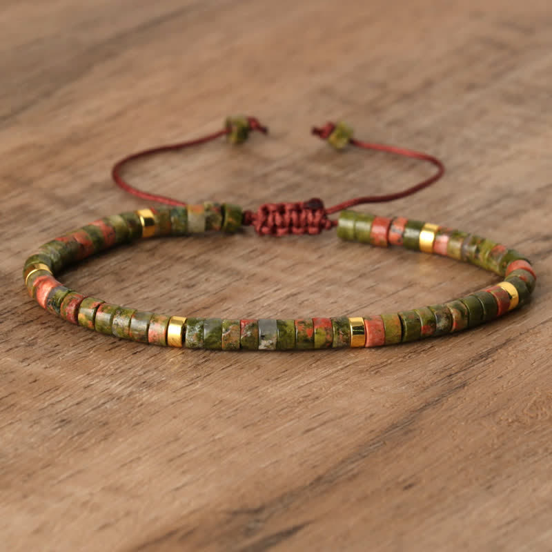 Elegant Seraphina women's bracelet with braided detailing & natural stone roller accents.