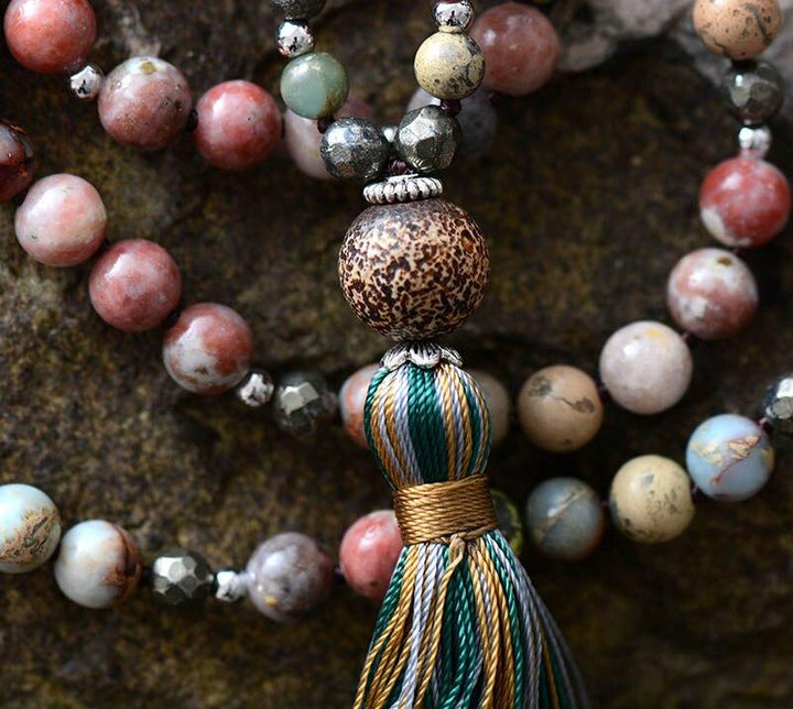 Healing women's mala necklace with rhodonite & hematite gemstones, ideal for meditation, yoga, or spiritual wear.