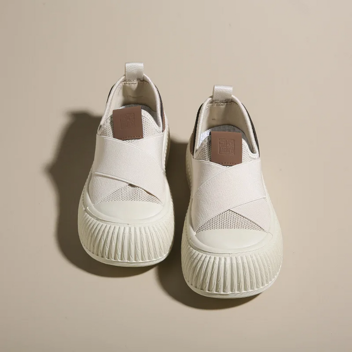 Close-up of white Seraphine platform slip-on sneakers, highlighting laceless & textile detail.