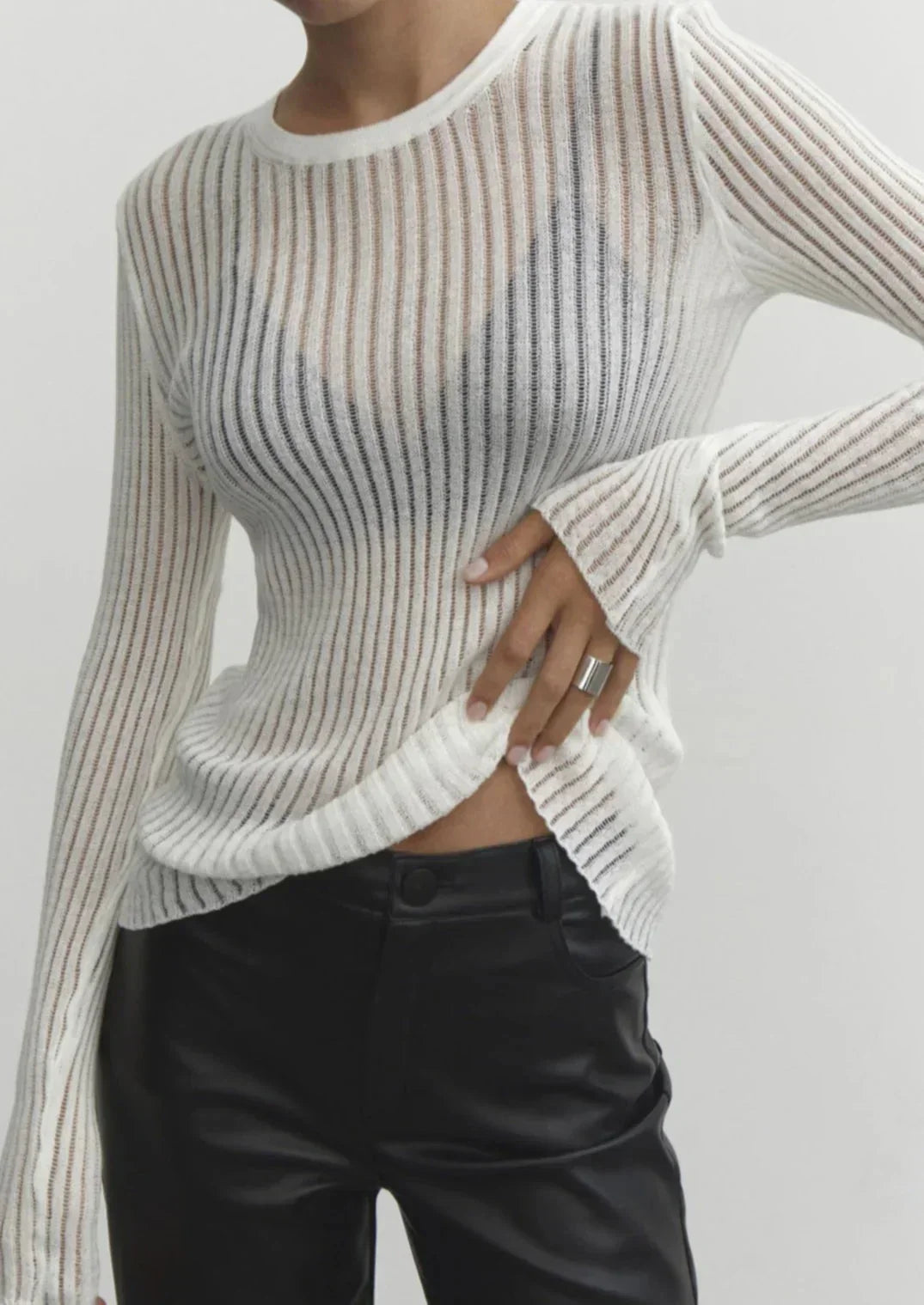 Fitted women's sheer ribbed long sleeve top. Elegant texture, perfect for layering or stand-alone chic.