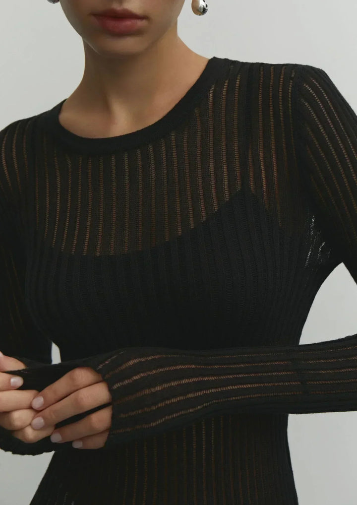 White sheer ribbed long sleeve top. Elegant, fitted women's fashion. Ideal for chic, versatile layering.