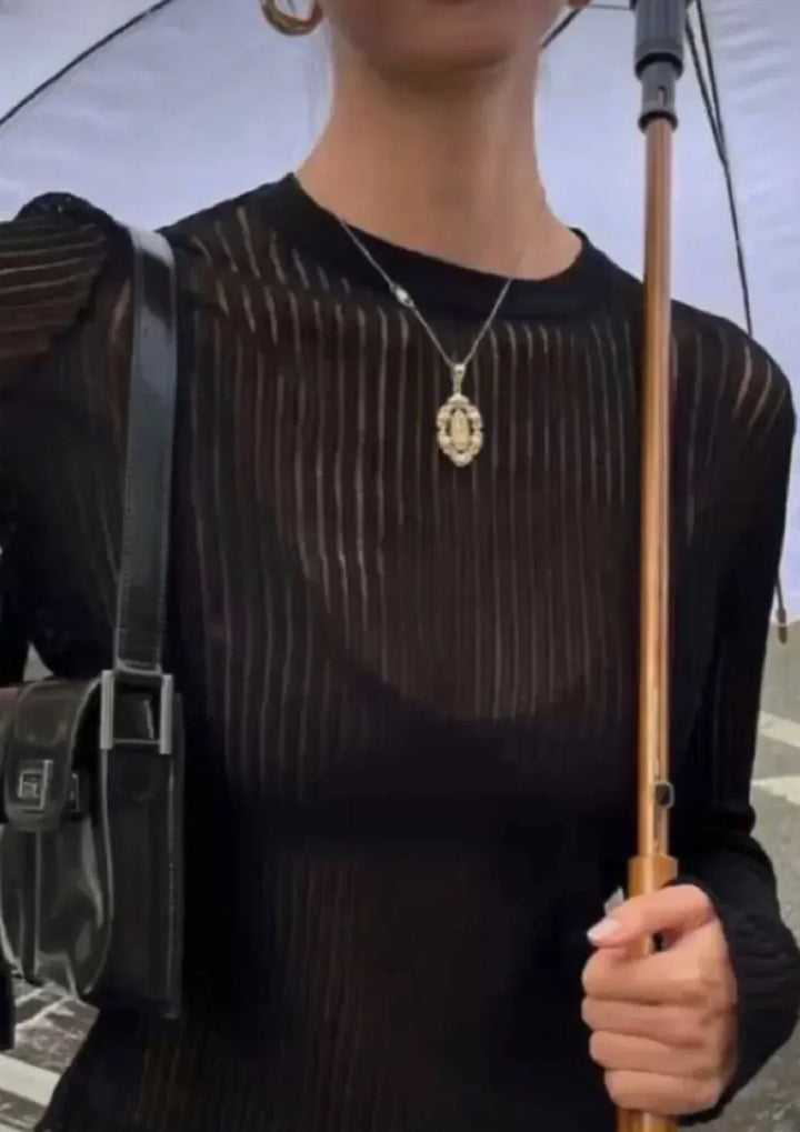 Women's fitted sheer ribbed long sleeve top. Chic, comfortable, versatile. A wardrobe essential for any style.