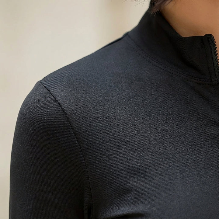Close-up of the cotton blend fabric on a women's Shelby half-zip long sleeve shirt, showing texture.