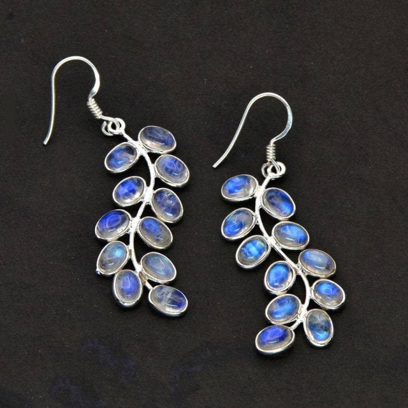 Women's shimmering moonstone drop earrings with elegant silver dangle design. Natural gemstone jewelry.