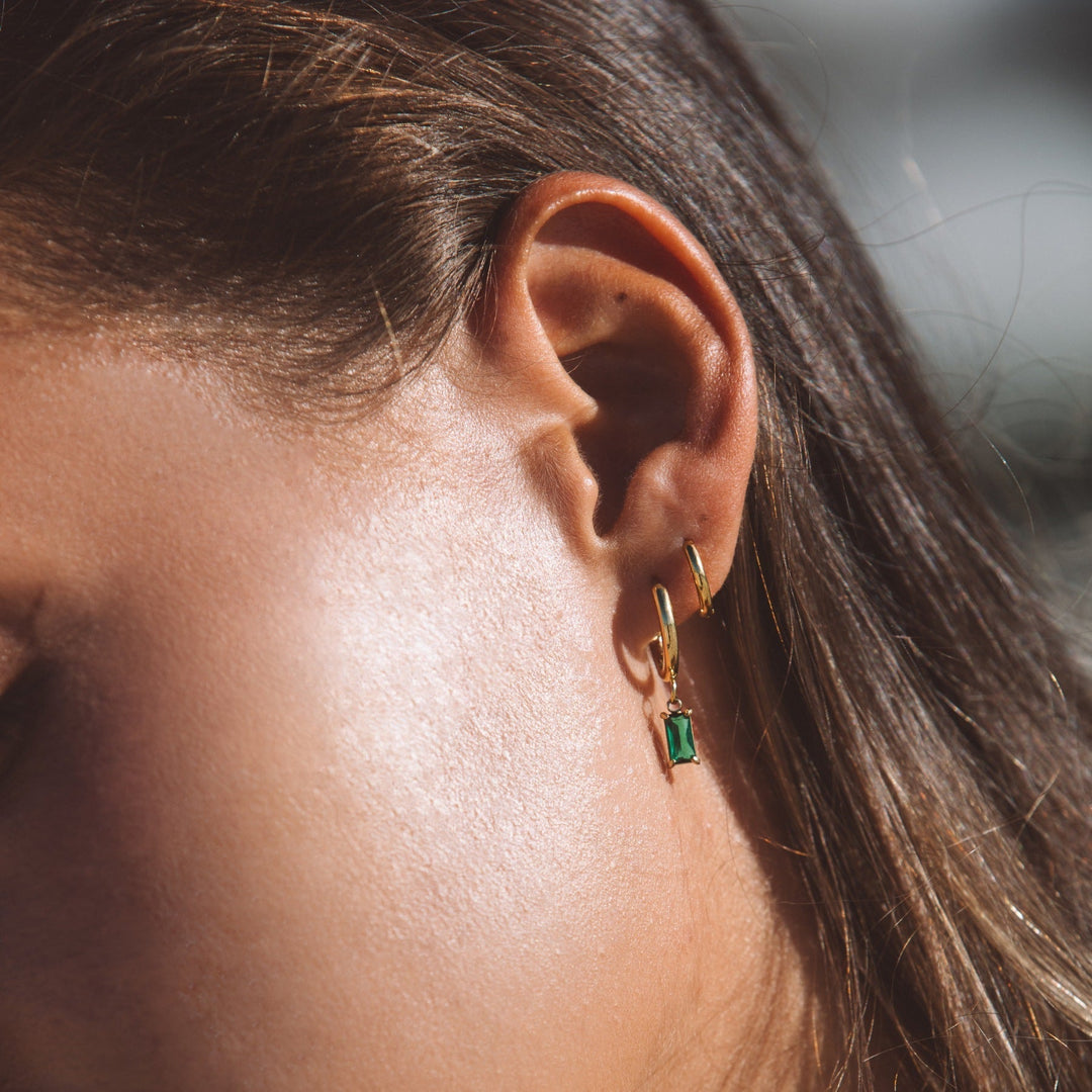 Close-up of sparkling ocean drop earrings for women. Crystal dangle jewelry, a perfect gift.