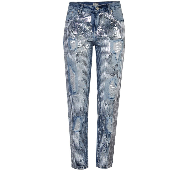 Women's shimmering sequin ripped jeans, a sparkling denim statement piece for party wear. Distressed, casual chic.