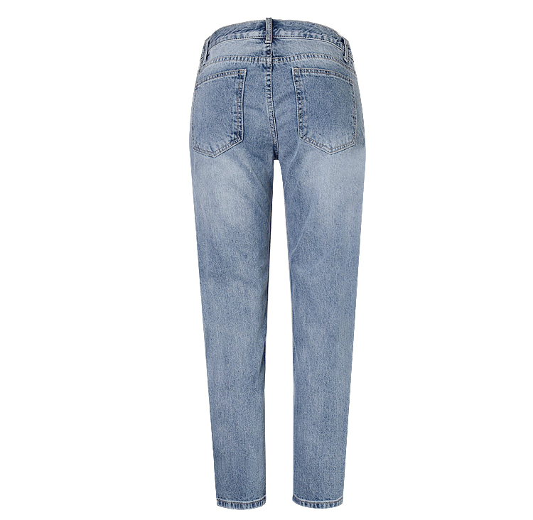 Close-up of women's ripped jeans with dazzling sequin embellishments, perfect for party fashion & statement look.