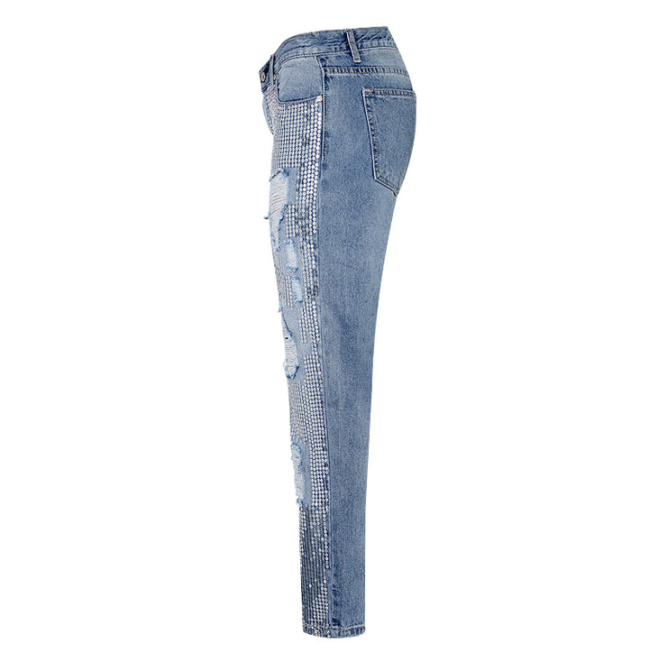 Stylish women's distressed denim jeans, featuring shimmering sequin details and trendy rips for a unique party outfit.