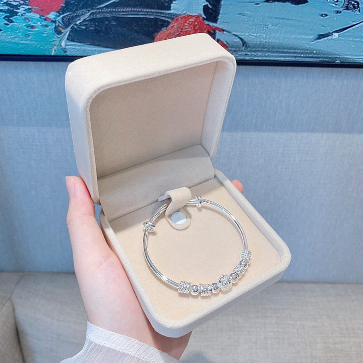 Women's shimmering silver luck bead bracelet, adjustable and elegant jewelry.