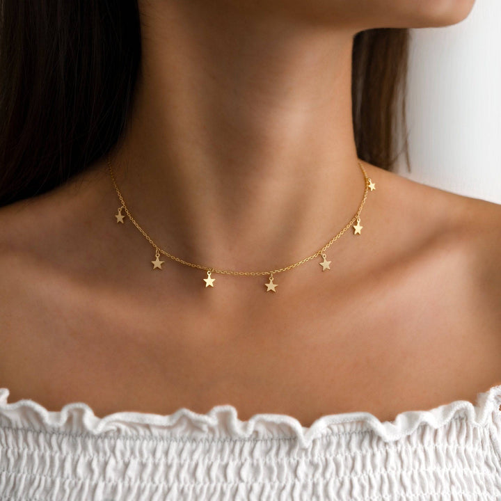 Women's shimmering star necklace, gold plated & silver, delicate celestial jewelry for everyday wear.