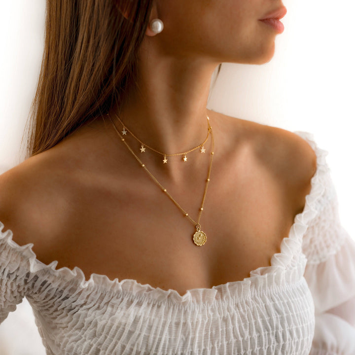 Elegant women's shimmering star necklace, two-tone gold plated & silver, celestial and delicate.