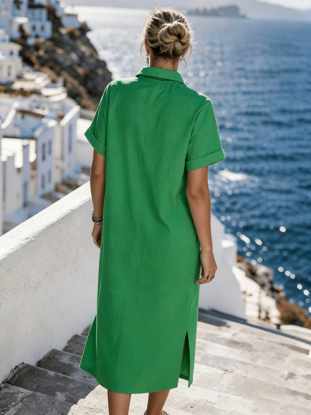 Model wearing a women's short sleeve button-front resort wear shirt dress walking.
