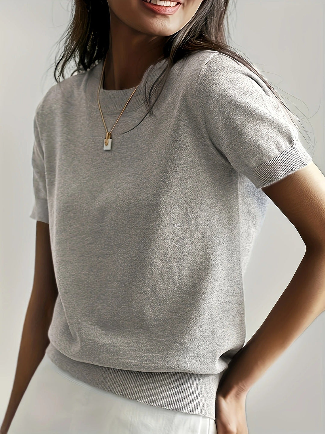 Elegant women's crew neck knit tee, short sleeves, ribbed hem. Ideal for spring fashion.