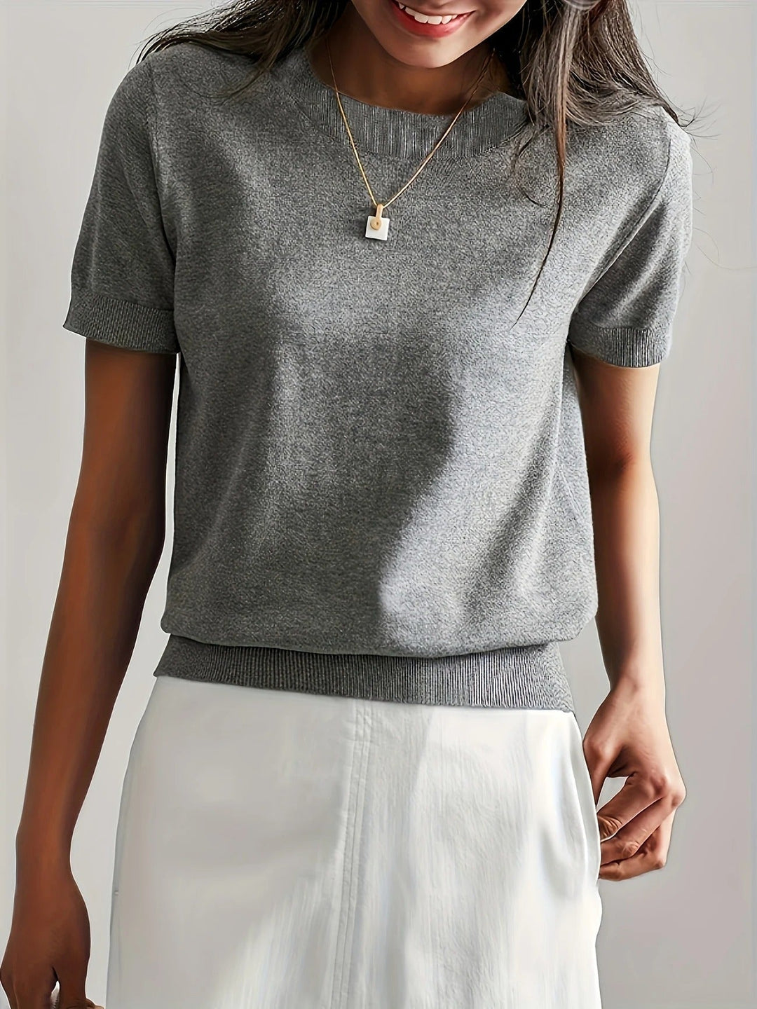 Chic women's crew neck tee, short sleeves, ribbed hem. Perfect for versatile everyday wear.