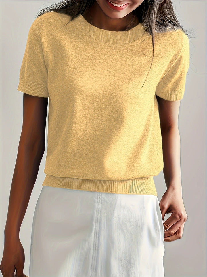 Women's spring knit top, short sleeves, crew neck, ribbed hem. Chic and comfortable everyday wear.