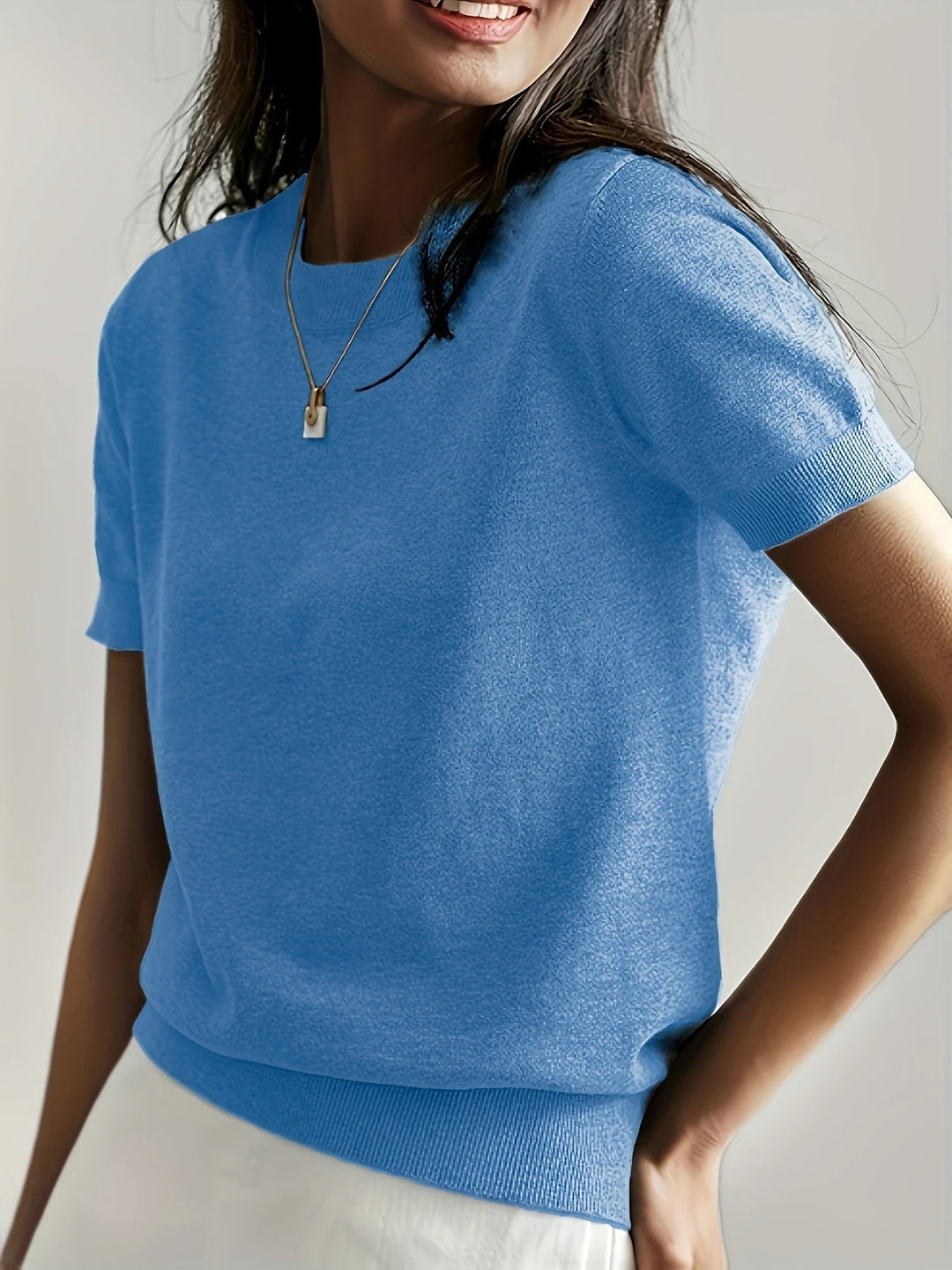 Women's versatile knit tee with a crew neck, short sleeves, and stylish ribbed hem detail.