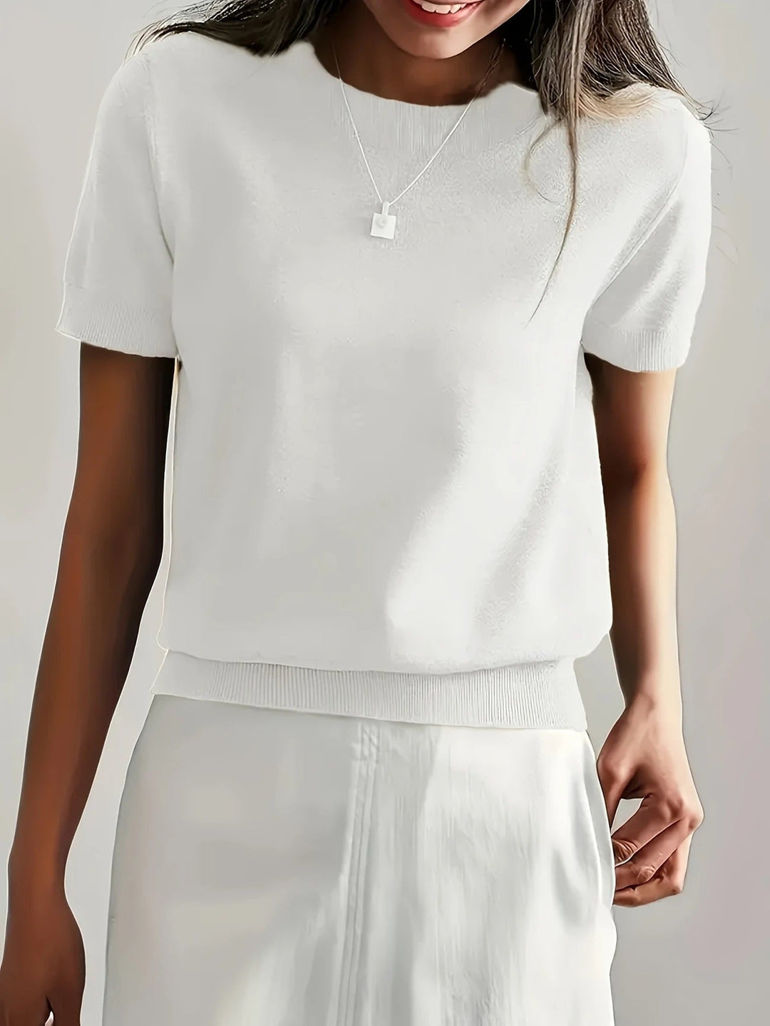 Stylish women's crew neck short sleeve tee, ribbed hem. Versatile and chic for everyday wear.
