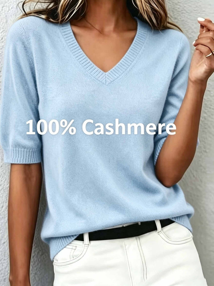 Stylish women's V-neck short-sleeve sweater, paired with trousers for a chic smart casual look.
