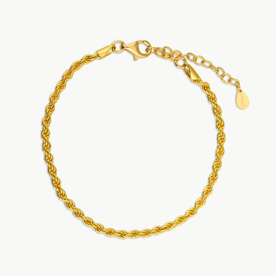 Woman modeling Sienna twisted link chain bracelet, a stylish gold-plated accessory, waterproof & durable.