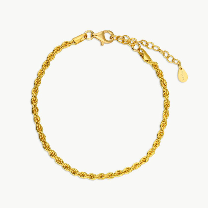 Woman modeling Sienna twisted link chain bracelet, a stylish gold-plated accessory, waterproof & durable.