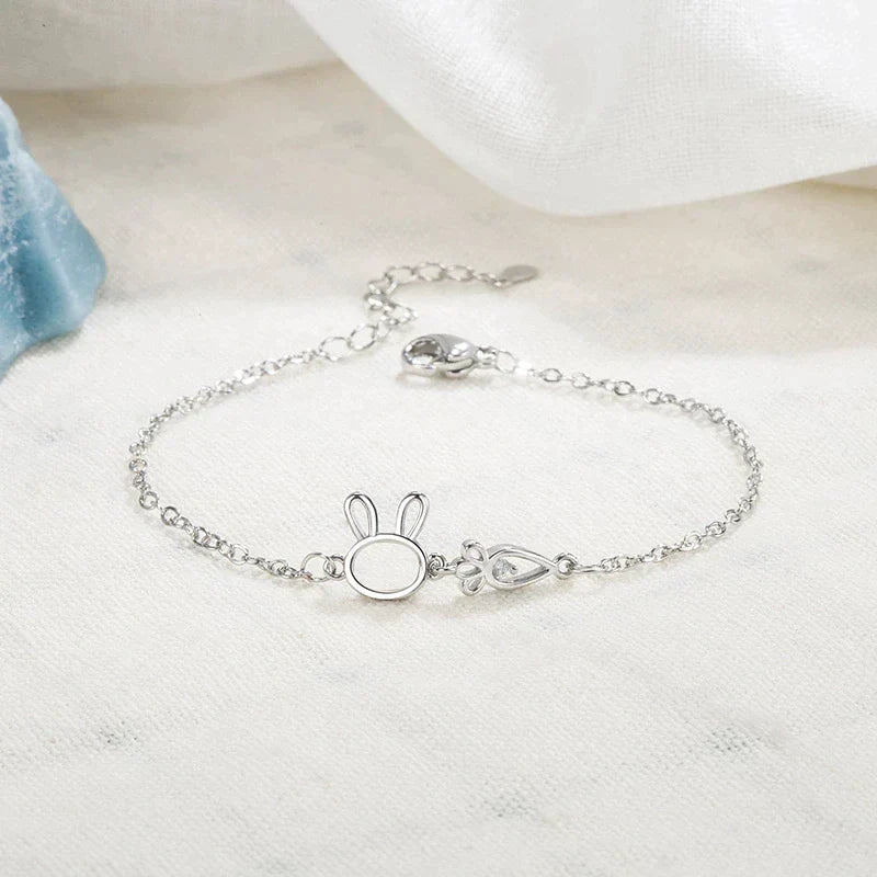 Women's silver charm bracelet with a charming rabbit pendant. Adjustable & delicate jewelry for a whimsical look.