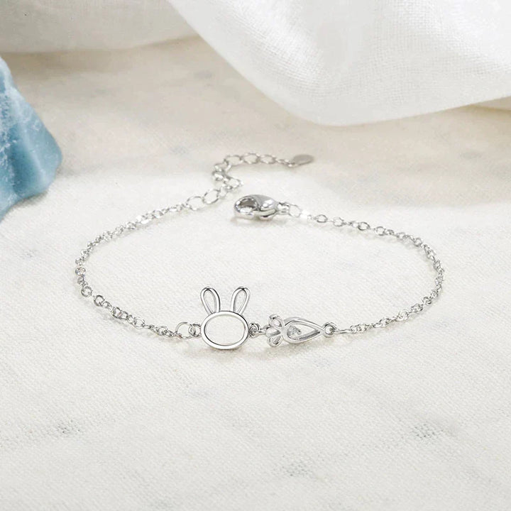 Women's silver charm bracelet with a charming rabbit pendant. Adjustable & delicate jewelry for a whimsical look.