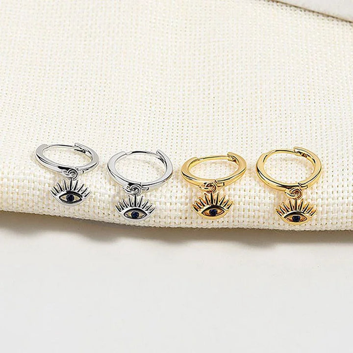 Elegant gold & silver plated evil eye earrings for women. Hypoallergenic dangle jewelry, a protective fashion statement.