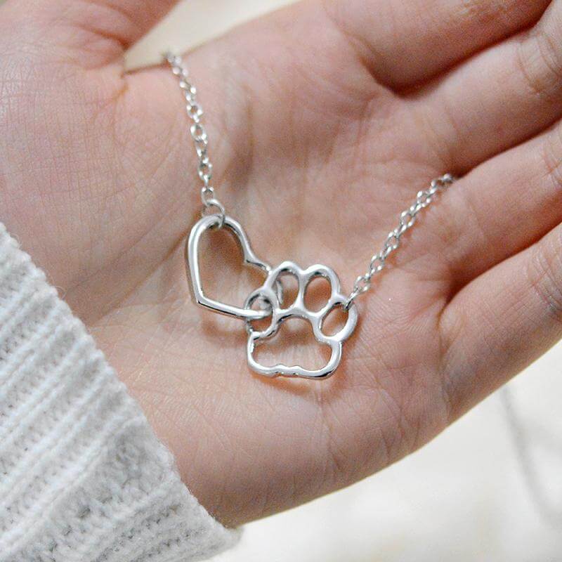 Close-up of a delicate paw print heart necklace, a beautiful tribute for any animal lover.