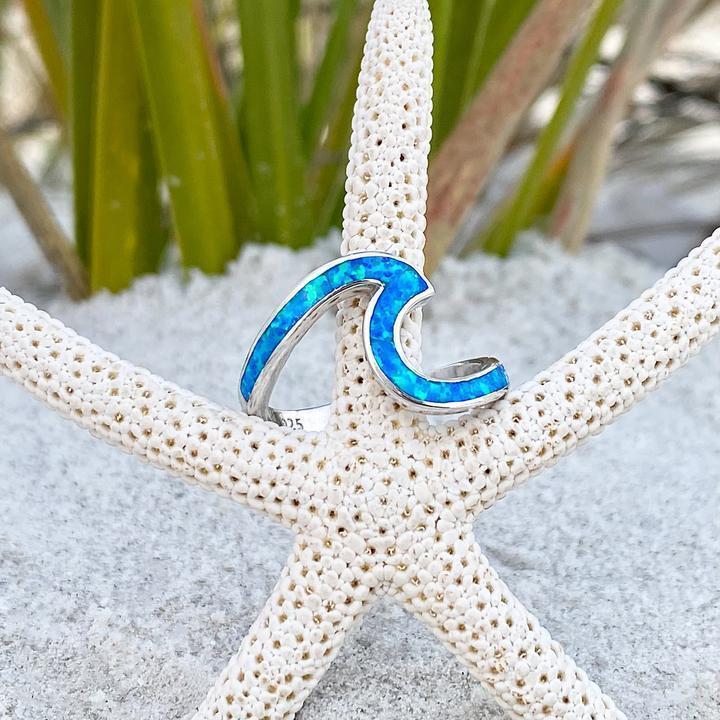 Elegant women's handmade silver sea wave ring featuring a stunning blue opal gemstone, nature-inspired.