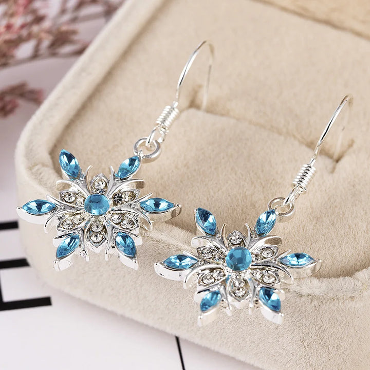 Sparkling Christmas snowflake dangle earrings, women's festive winter holiday jewelry.