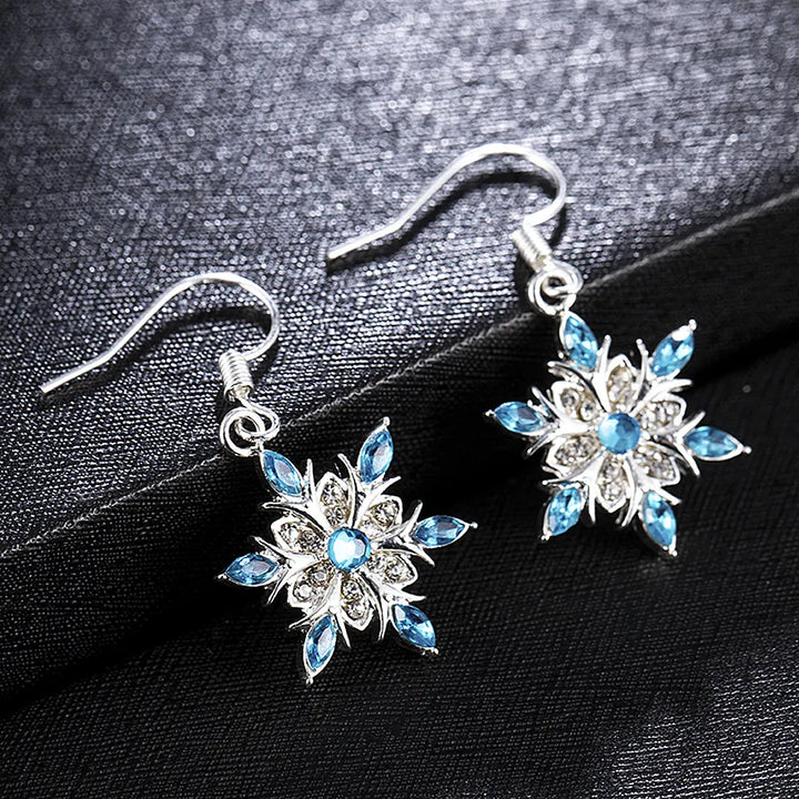 Beautiful silver snowflake dangle earrings, ideal women's festive Christmas accessory.
